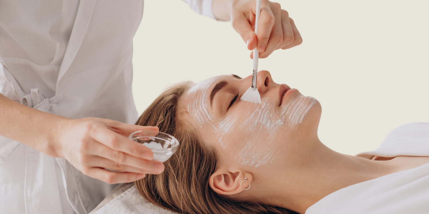 Esthetician applying anti-aging serum to improve skin elasticity and smooth wrinkles.